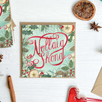 Nollaig Shona Irish Christmas-themed card with watercolour painted decorative elements on a white surface