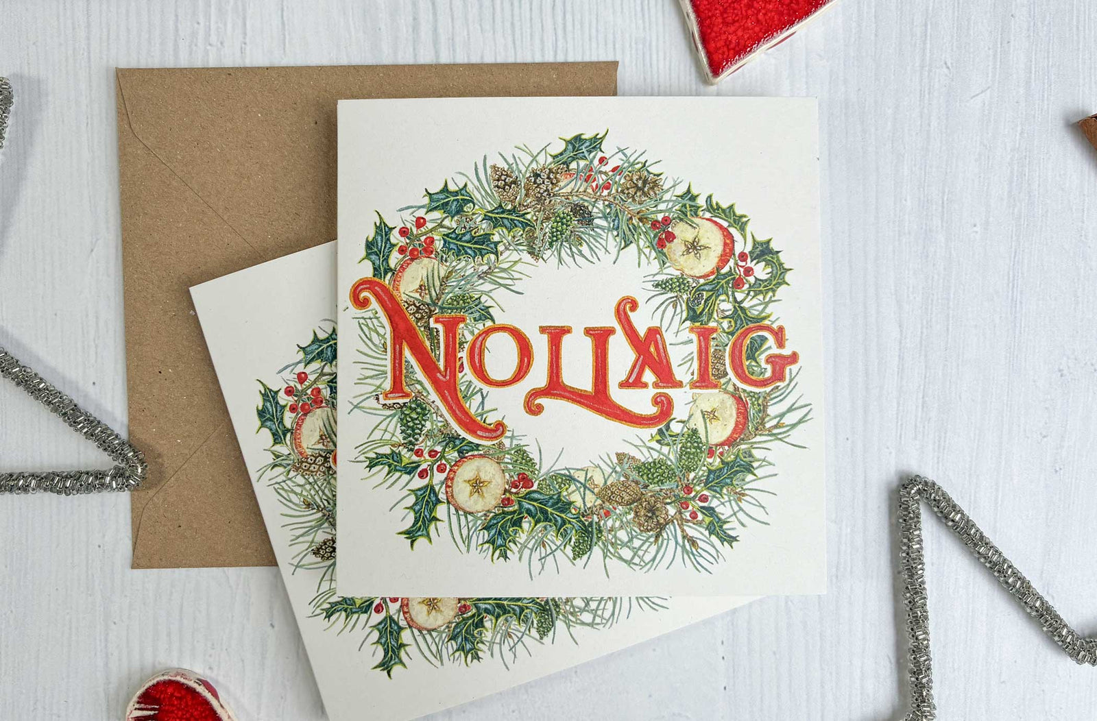 Irish Wreath Christmas-themed card with watercolour painted decorative elements on a white surface